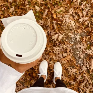 a person holding a cup of coffee