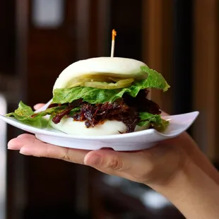 Our House Special Beef Sandwich Bao is flavorful beef with lettuce and pickles wrapped in a soft steamed bun. Yummy!