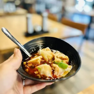 a person holding a bowl of food