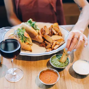 a plate of food and a glass of wine