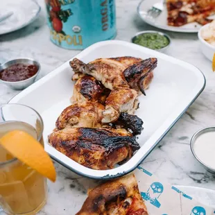 a table with pizza and drinks