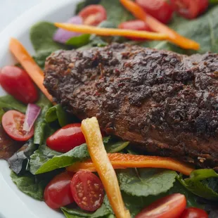 a plate of meat and vegetables