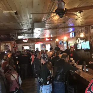 a crowd of people sitting at the bar