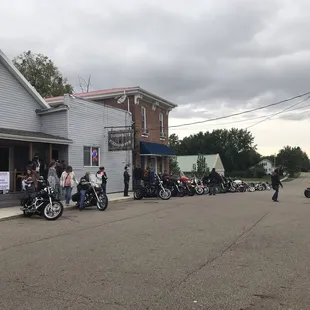 a line of motorcycles parked in front of a restaurant
