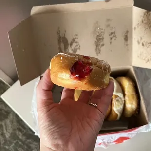 a hand holding a donut