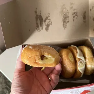 a hand holding a donut