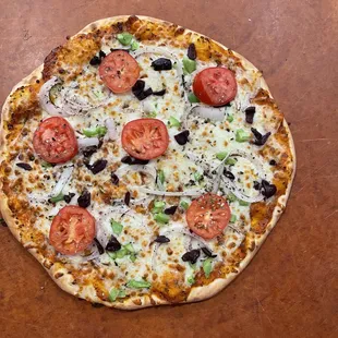 Cheese Pizza: homemade sauce, mozzarella cheese, olives, green peppers,red onion and tomatoes.