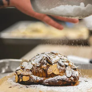 a pastry being sprinkled with powdered sugar