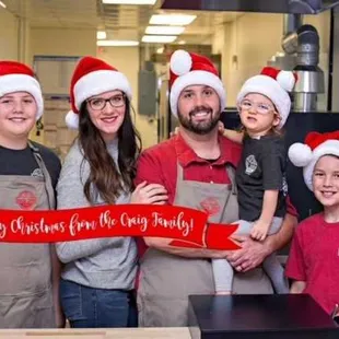 a group of people wearing santa hats