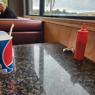 a soda and a red cup on a table