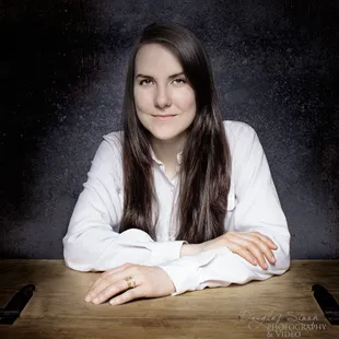 Portrait against a grey backdrop with composite background.