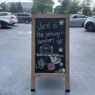 a chalk board with a sign saying june is the getaway to summer