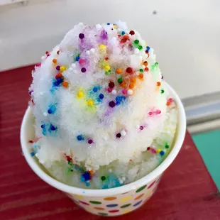 a cup of ice cream with sprinkles