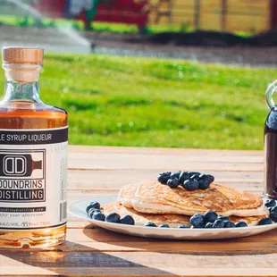 a plate of pancakes and syrup