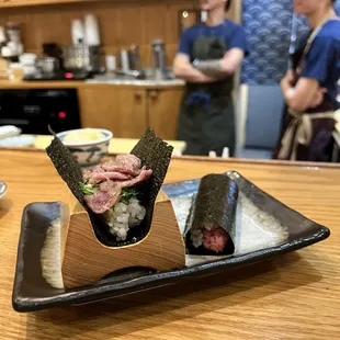 two sushi rolls on a plate