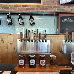 a row of beer glasses on a bar