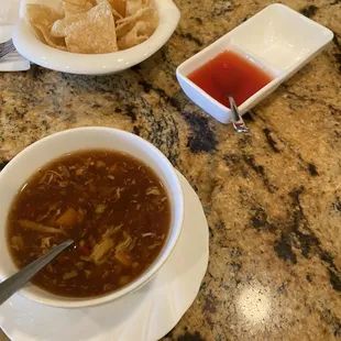hot and sour soup that comes with lunch special. top of photo is the free chips that come to table