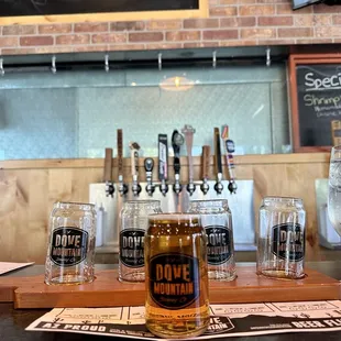 a row of beer glasses on a bar
