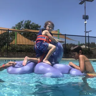 Climbing on the octopus in the deep end.