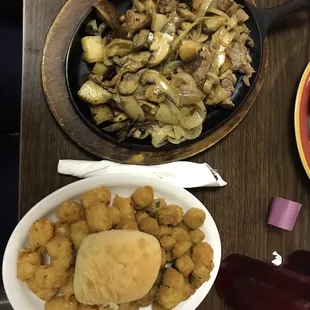 a plate of mushrooms and a bowl of tater tots