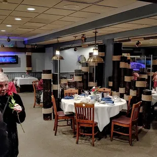 a group of people sitting at tables in a restaurant