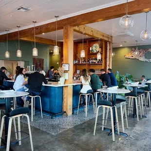 people sitting at tables in a restaurant