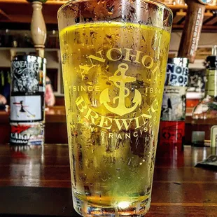 a pint of beer on a bar