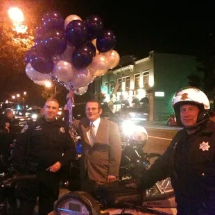 a man on a motorcycle with a bunch of balloons