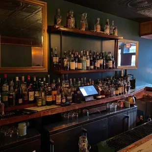 a bar with many bottles of alcohol