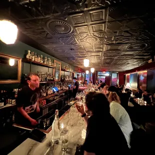 a group of people sitting at a bar