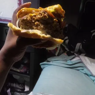 a hand holding a sandwich