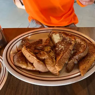 a plate of french toast and french fries