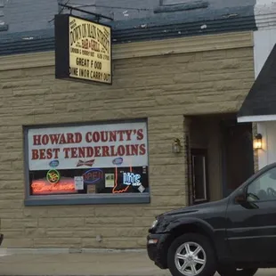 a car parked in front of a restaurant