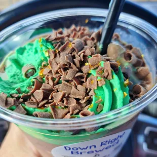 Topped with shaved chocolate, gold sprinkles, and homemade green whipped cream!