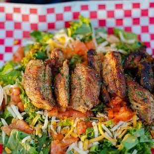 Our Cajjun Grilled Chicken Salad! Lettuce, tomato, cheese, and our Cajjun Grilled Chicken!