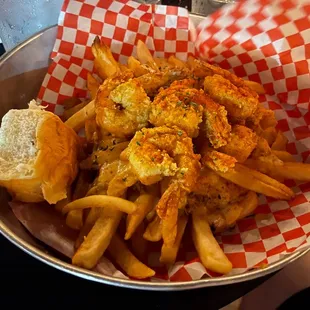 Cajun shrimp on a bed of fries with sauce