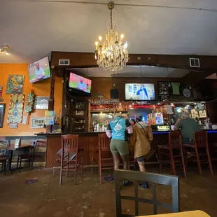 two people standing at a bar