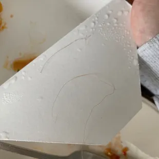 a person cutting a piece of paper with a fork
