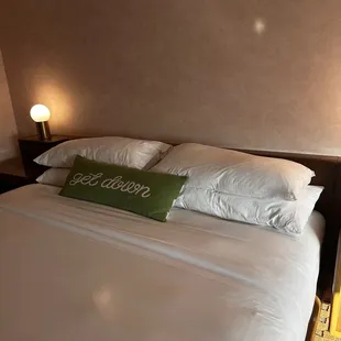 Bed - no headboard or decor above it - just salmon wallpaper