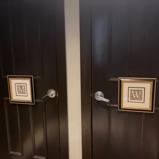 a bathroom with two black doors