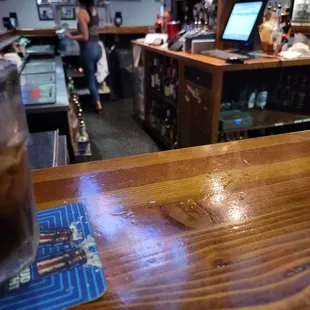 a wooden bar with a beverage on it