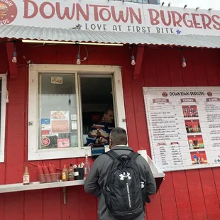 a man standing in front of a red building