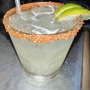 a margarita with a lime wedge