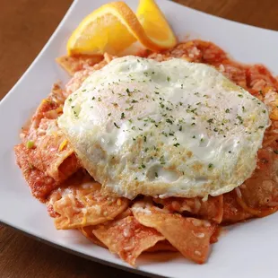 a plate of pasta with a fried egg