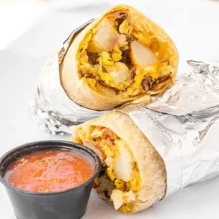 a burrito with a side of salsa