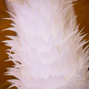 a white cake with feathers on top