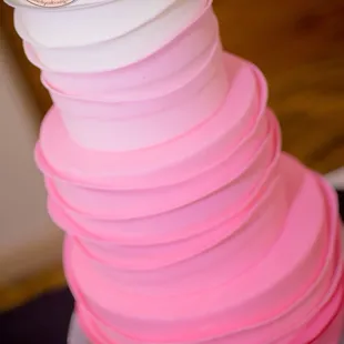 a pink and white wedding cake