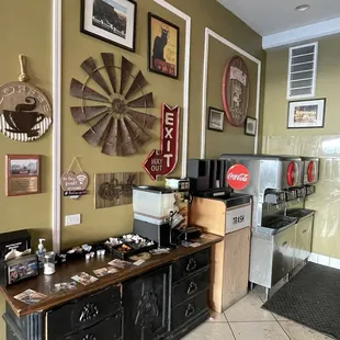 Soda machine, creamer, sugar, and other self serve amenities.