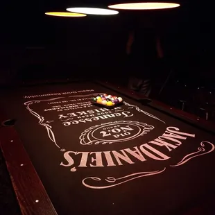 a pool table lit up at night