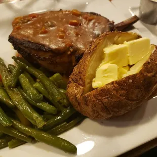 Smoked pork chop with sauteed green beans and baked potatoe